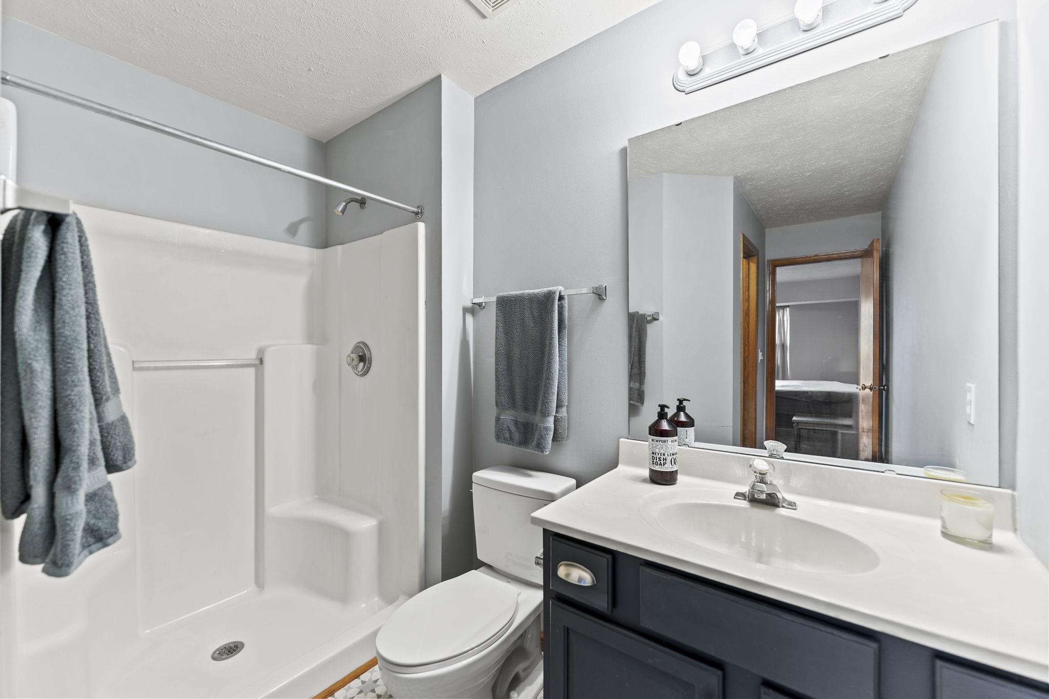 5694 Oak Village Drive Roscoe, IL 61073 - Photo 17 of 22 a bathroom with a sink a toilet and shower