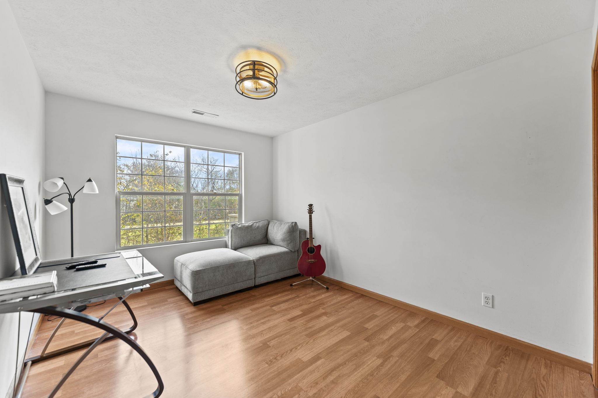 5694 Oak Village Drive Roscoe, IL 61073 - Photo 18 of 22 a spacious bedroom with a bed and a large window