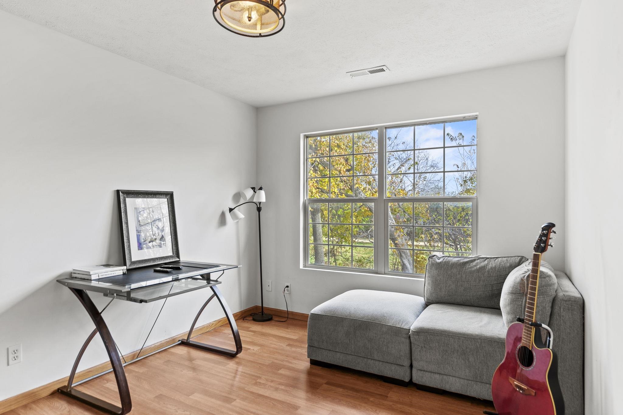 5694 Oak Village Drive Roscoe, IL 61073 - Photo 19 of 22 a living room with furniture and a window
