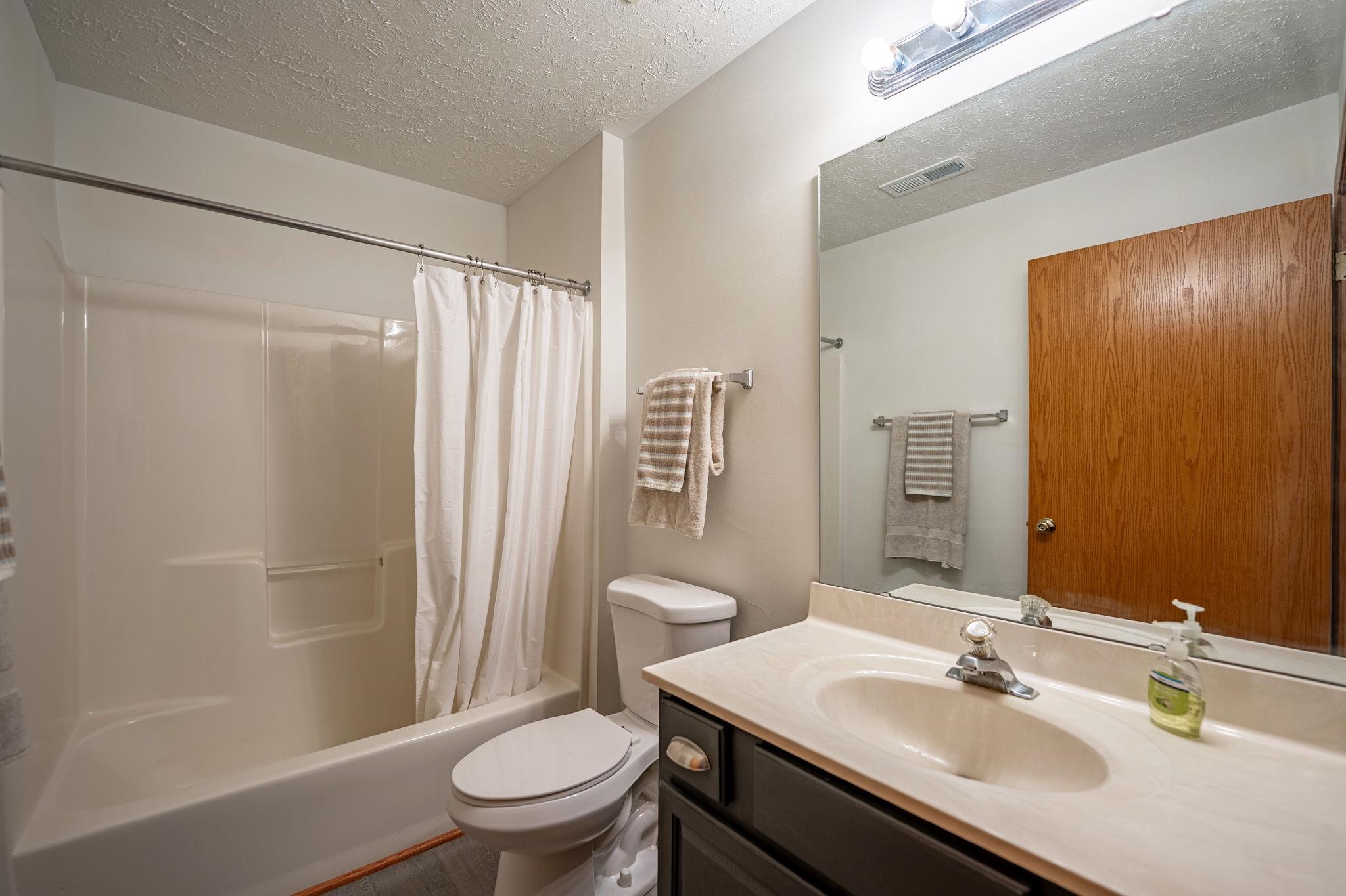5694 Oak Village Drive Roscoe, IL 61073 - Photo 20 of 22 a bathroom with a sink toilet and shower