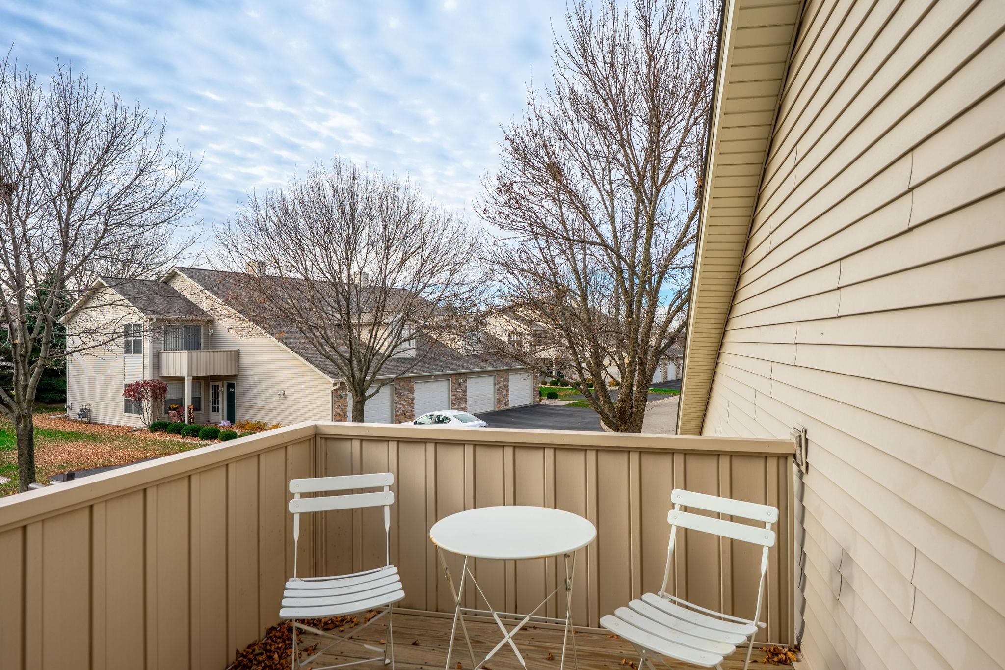 5694 Oak Village Drive Roscoe, IL 61073 - Photo 21 of 22 a view of a chair and table in the balcony