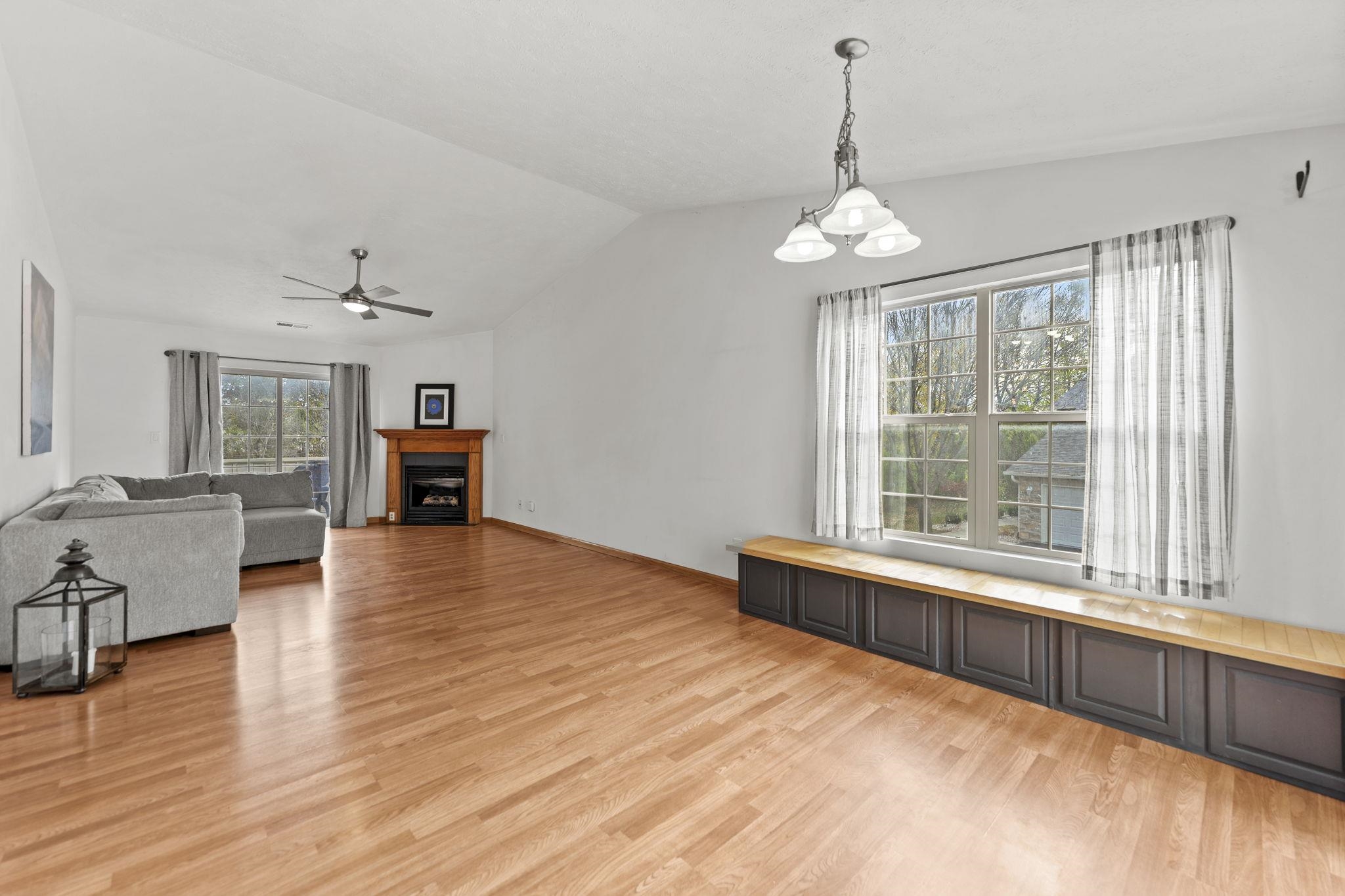 5694 Oak Village Drive Roscoe, IL 61073 - Photo 4 of 22 a view of an empty room with wooden floor and a window