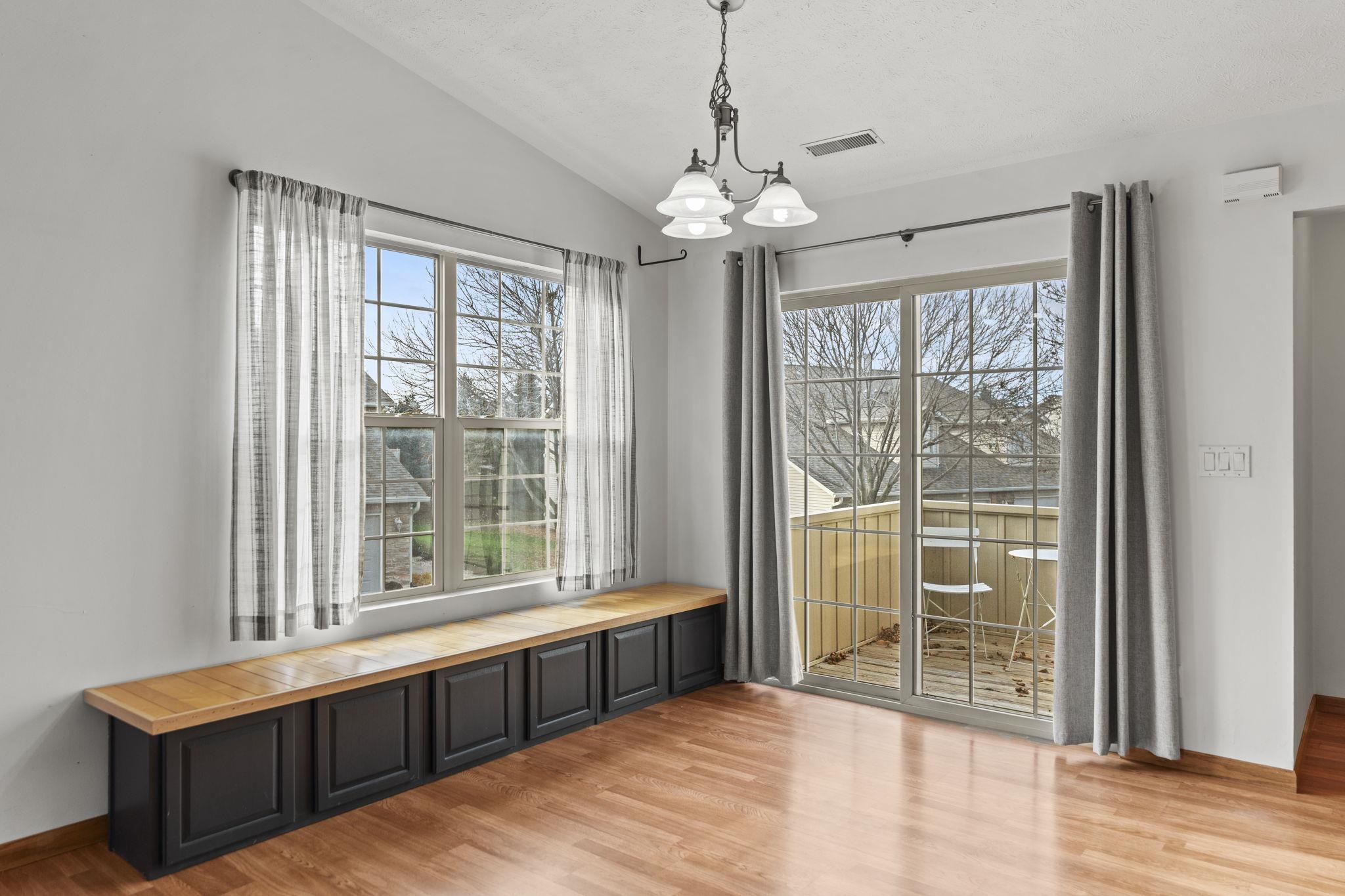 5694 Oak Village Drive Roscoe, IL 61073 - Photo 5 of 22 a view of an empty room with wooden floor and a window