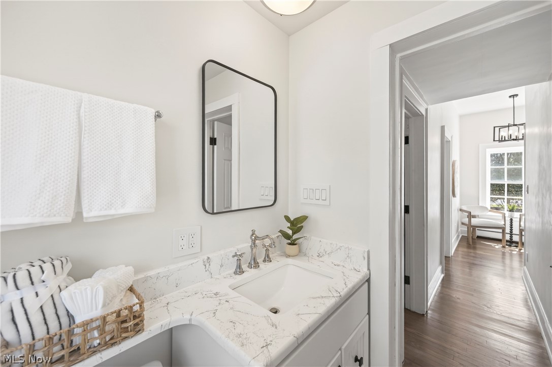 14939 Caves Road Novelty, OH 44072 - Photo 29 of 42 Bathroom with vanity, dark wood-style floors, and suspended lighting