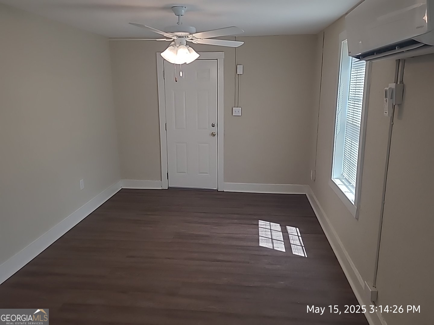 10 Hester Drive Dublin, GA 31021 - Photo 2 of 4 an empty room with wooden floor and windows
