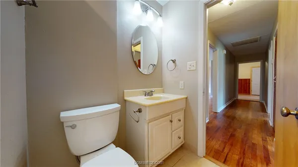 a bathroom with a toilet sink and mirror