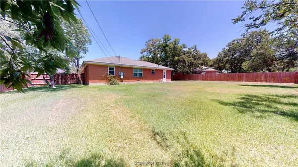 a view of a house with a yard and garage