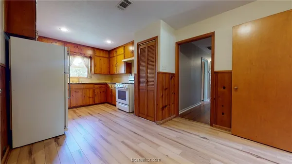 a kitchen with stainless steel appliances granite countertop a refrigerator and a stove