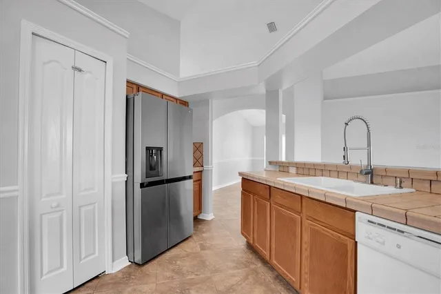 a kitchen with a refrigerator and a sink