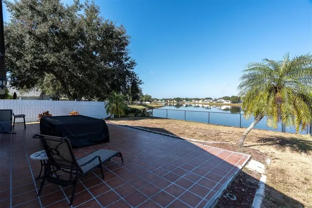 a view of a house with a yard and sitting area