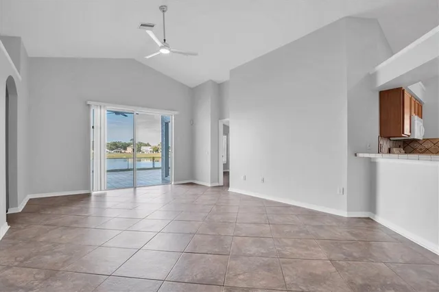 a view of kitchen with stove and cabinet