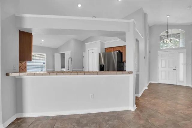 a view of kitchen with granite countertop cabinets and window