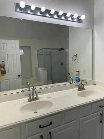 a bathroom with a sink double vanity and a mirror