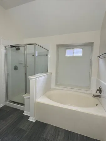 a white bath tub sitting next to a toilet