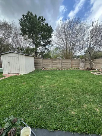 a backyard of a house with lots of green space and trampoline