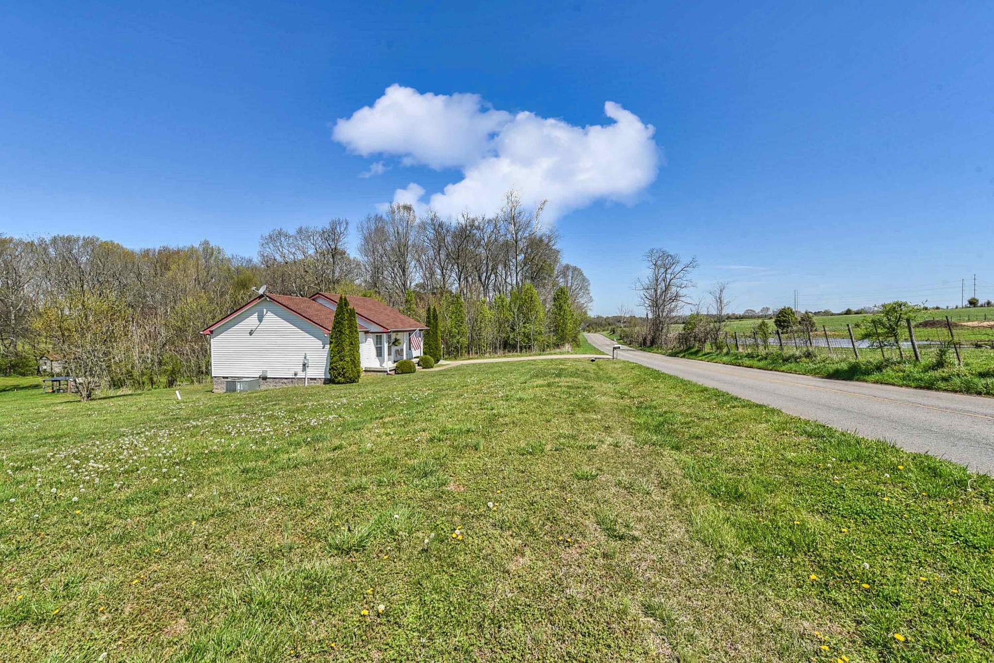 105 Tom Ferrell Road Portland, TN 37148 - Photo 5 of 31 a view of a big yard with potted plants and large tree
