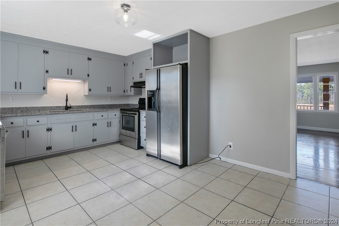 407 Ruth Street Spring Lake, NC 28390 - Photo 12 of 38 a kitchen with stainless steel appliances a refrigerator sink and microwave