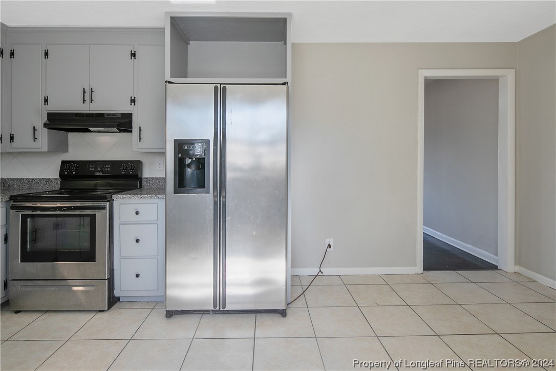 407 Ruth Street Spring Lake, NC 28390 - Photo 13 of 38 a kitchen with stainless steel appliances a refrigerator and a stove top oven