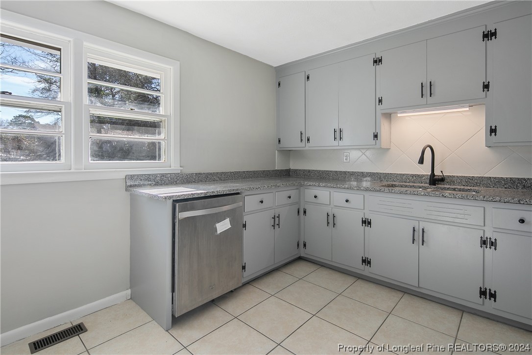 407 Ruth Street Spring Lake, NC 28390 - Photo 14 of 38 a kitchen with granite countertop white cabinets and white appliances