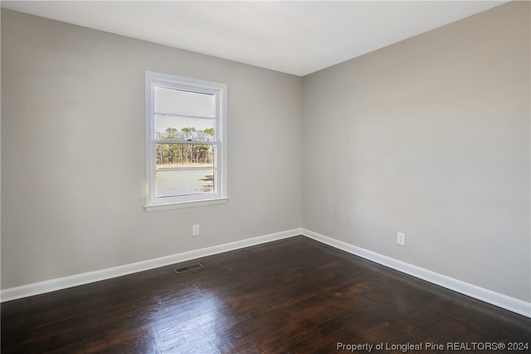 407 Ruth Street Spring Lake, NC 28390 - Photo 19 of 38 a view of a room with wooden floor and window