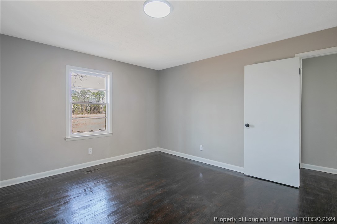 407 Ruth Street Spring Lake, NC 28390 - Photo 25 of 38 a view of a room that has wooden floor and windows in it
