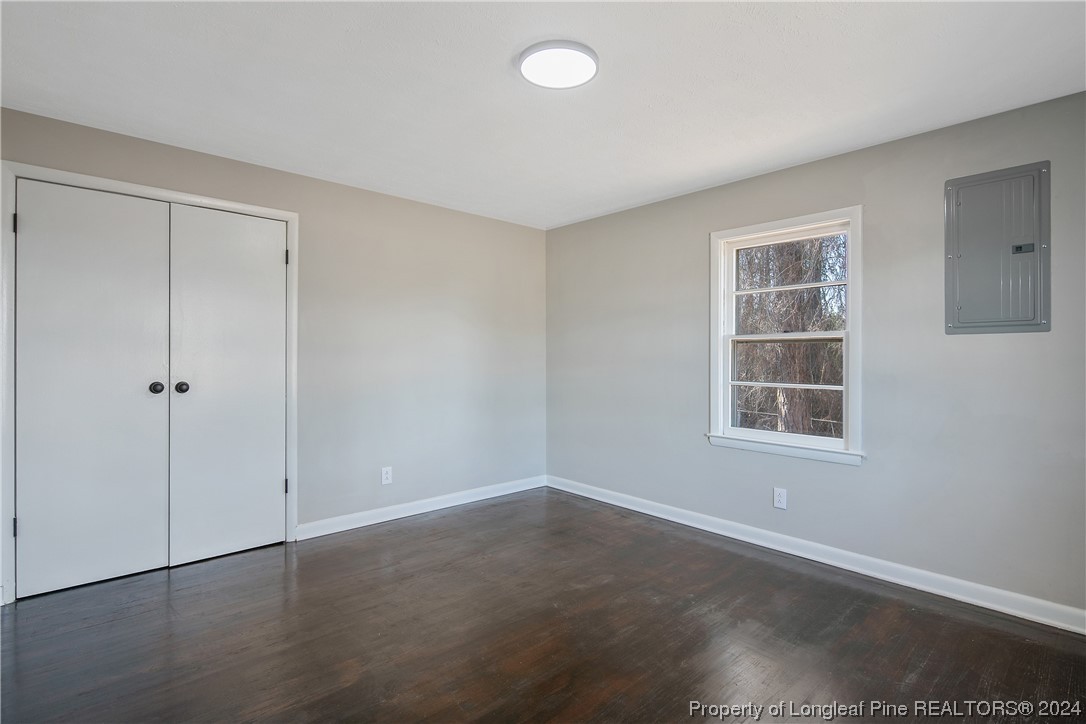 407 Ruth Street Spring Lake, NC 28390 - Photo 27 of 38 a view of an empty room with wooden floor and a window