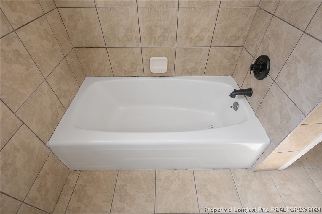 407 Ruth Street Spring Lake, NC 28390 - Photo 30 of 38 a bathroom with a bathtub