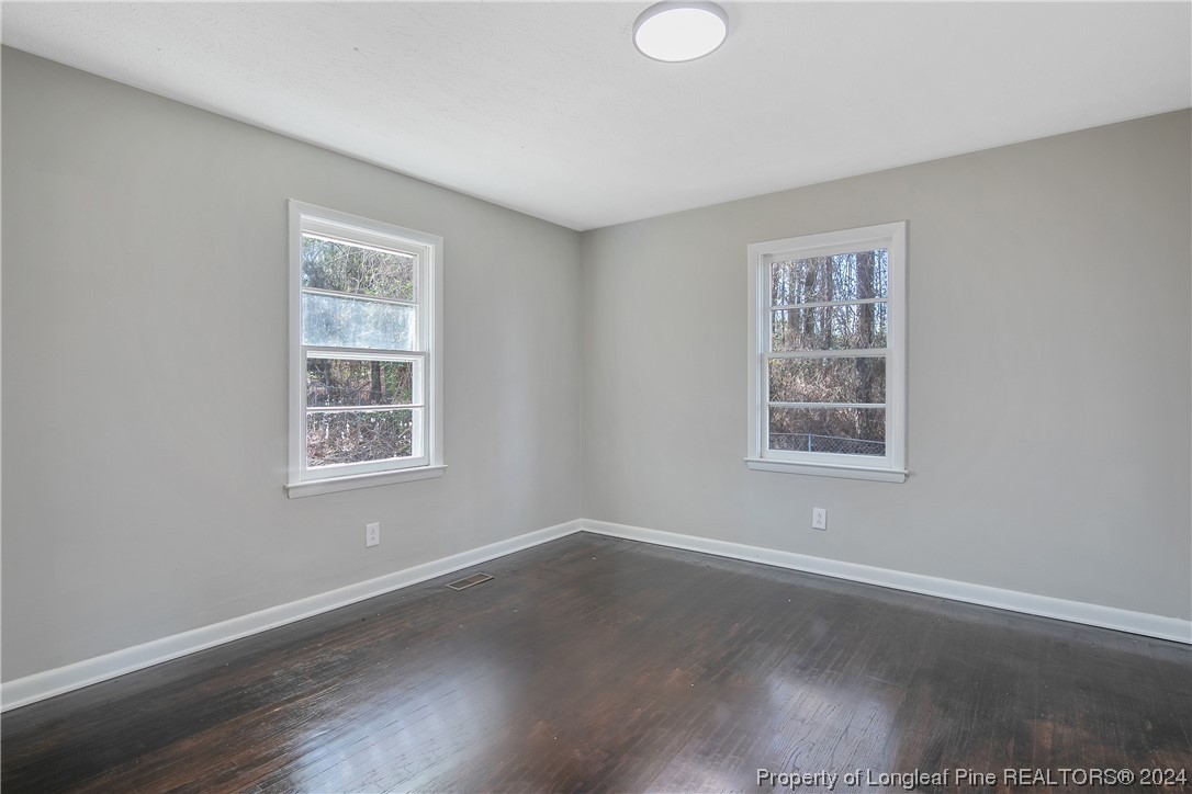 407 Ruth Street Spring Lake, NC 28390 - Photo 31 of 38 an empty room with wooden floor and windows