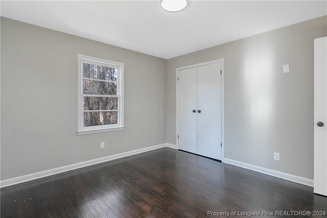 407 Ruth Street Spring Lake, NC 28390 - Photo 32 of 38 an empty room with wooden floor and windows