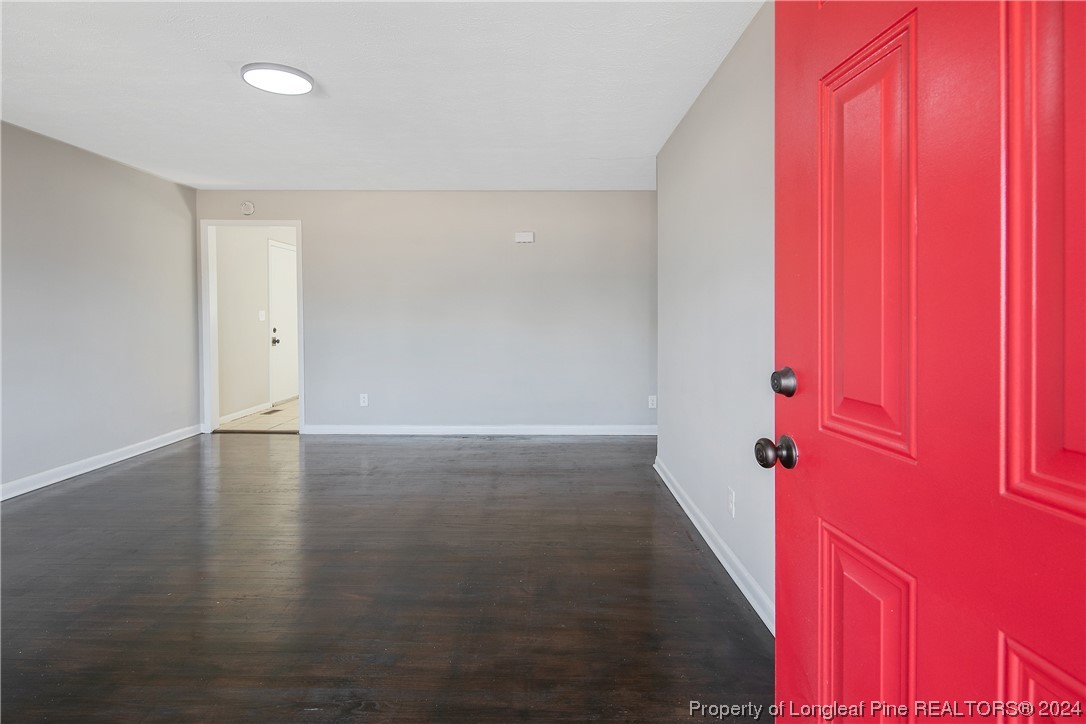 407 Ruth Street Spring Lake, NC 28390 - Photo 5 of 38 an empty room with wooden floor and windows