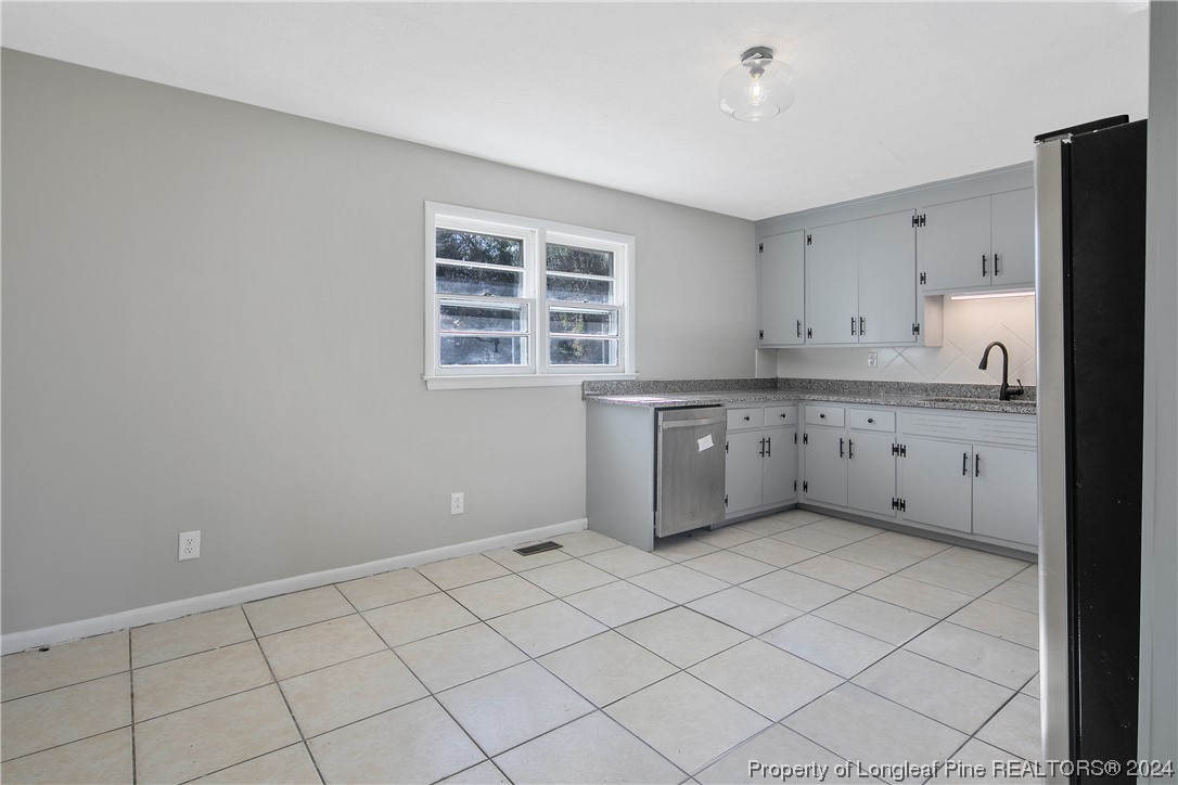 407 Ruth Street Spring Lake, NC 28390 - Photo 10 of 38 a kitchen with a cabinets and white appliances