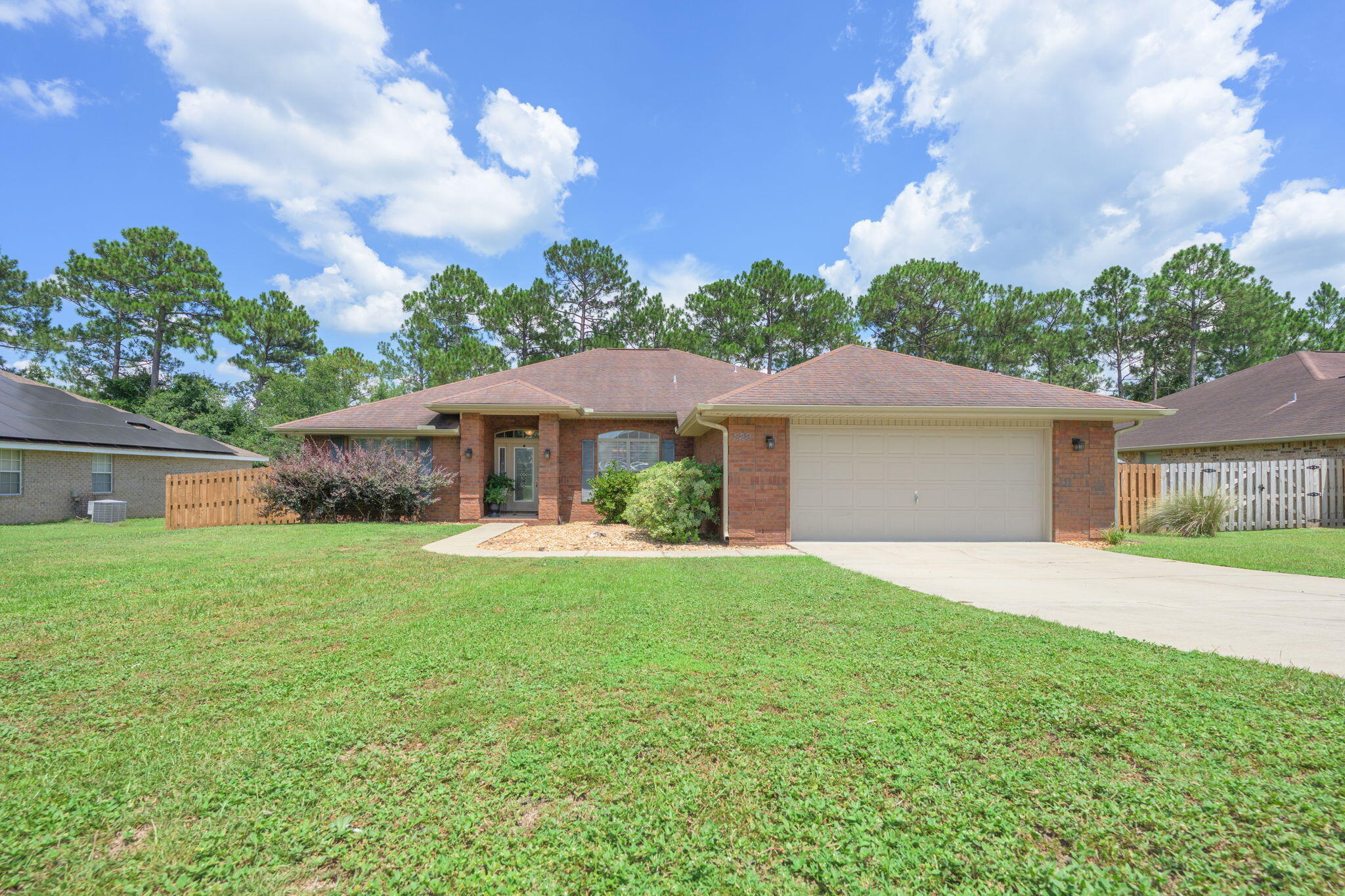 222 Raptor Drive Crestview, FL 32536 - Photo 2 of 70 a front view of a house with a garden and yard
