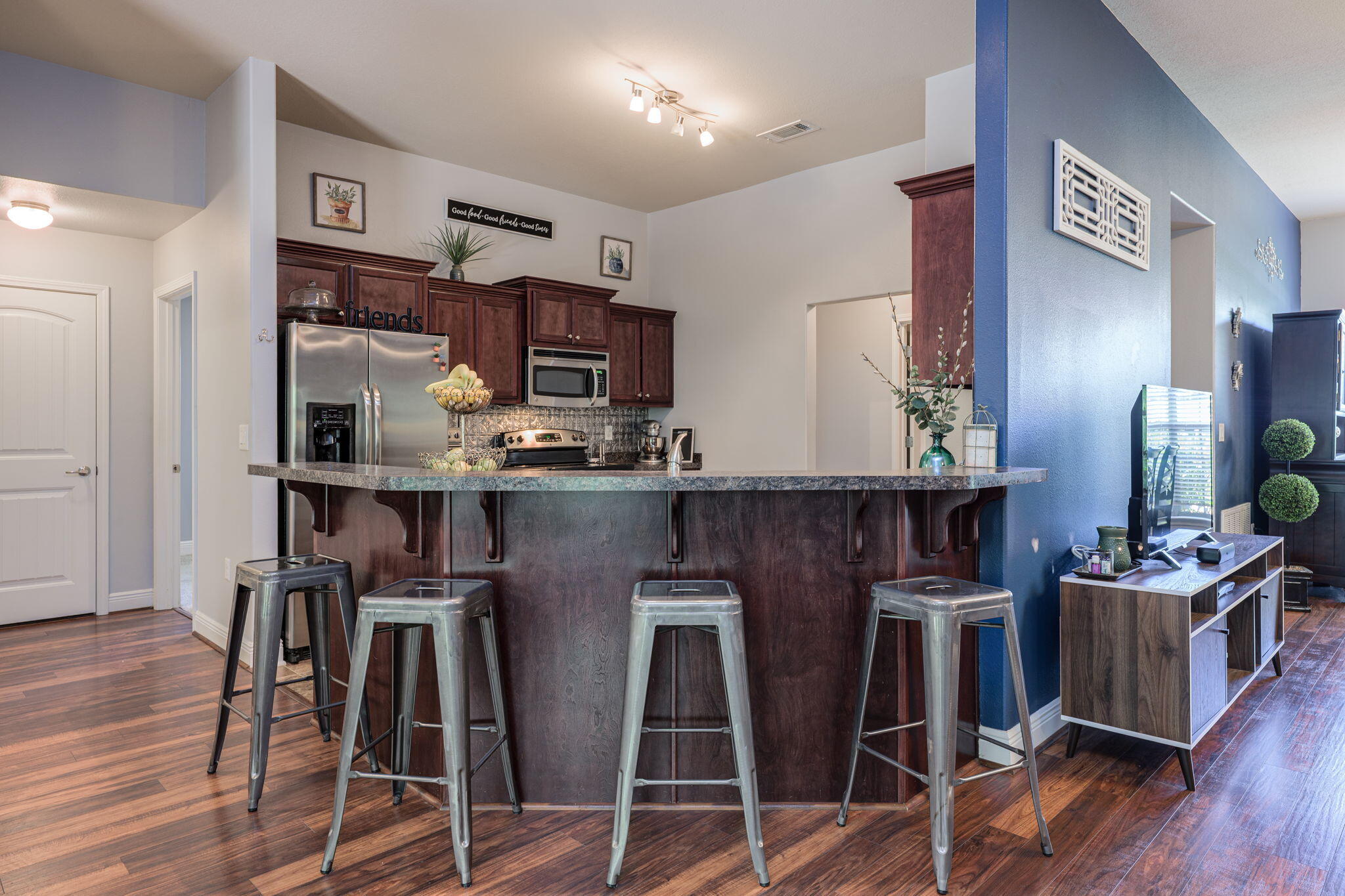 222 Raptor Drive Crestview, FL 32536 - Photo 25 of 70 a kitchen with kitchen island stainless steel appliances a counter top space and wooden floor