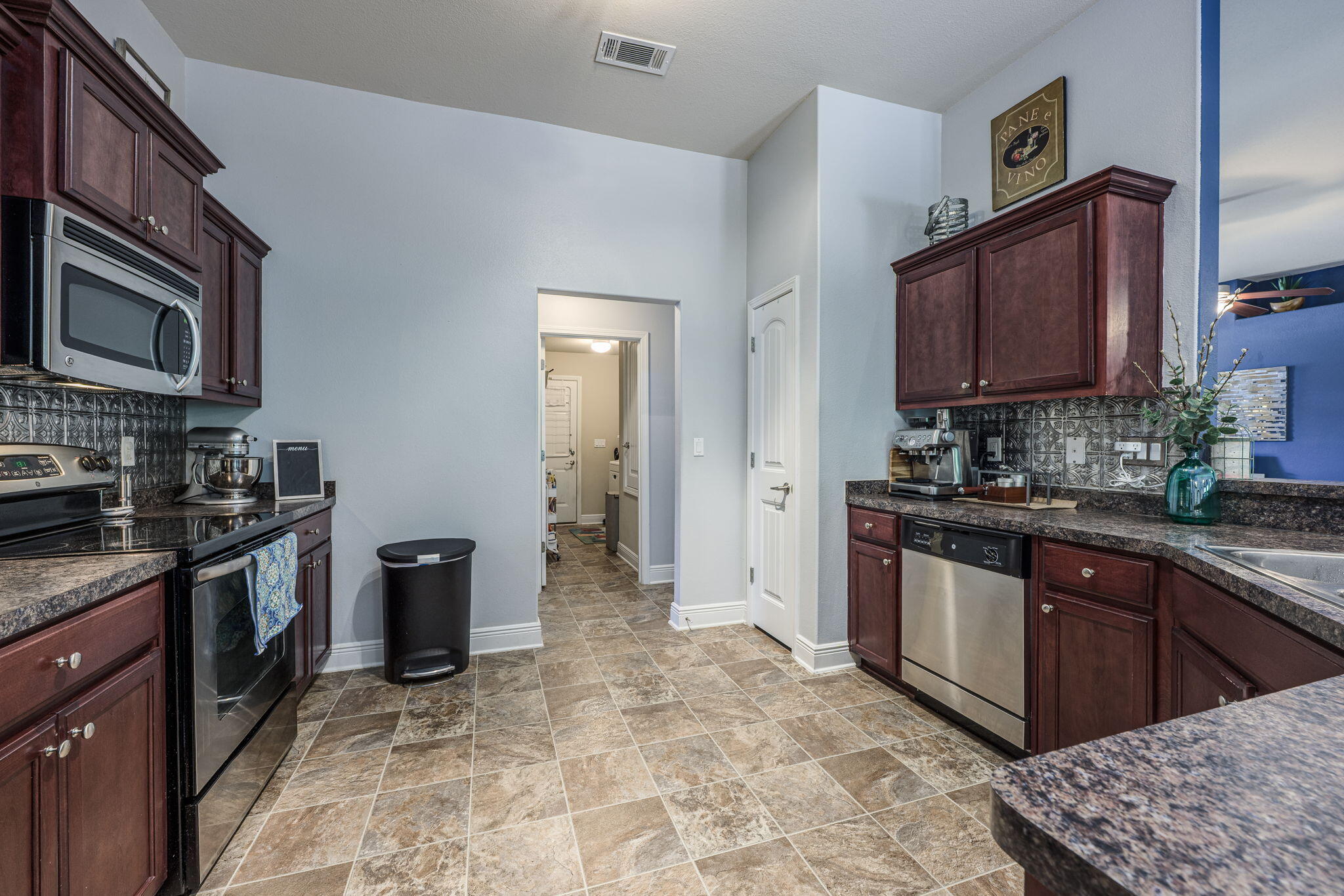 222 Raptor Drive Crestview, FL 32536 - Photo 26 of 70 a kitchen with stainless steel appliances granite countertop a stove sink and cabinets