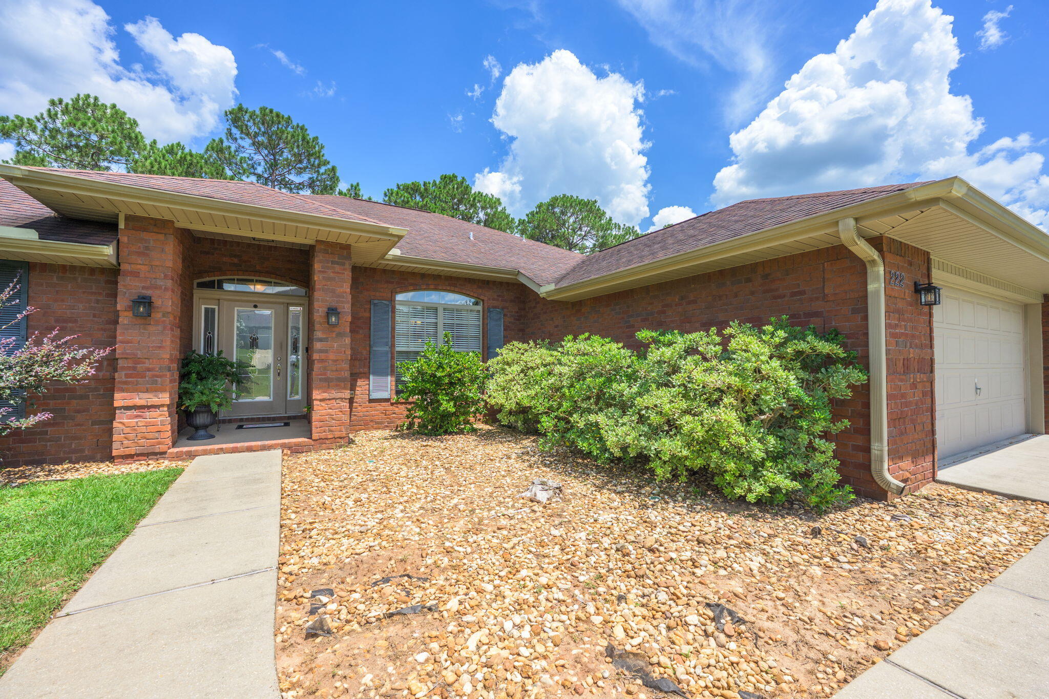 222 Raptor Drive Crestview, FL 32536 - Photo 10 of 70 a view of a house with a small yard and floor to ceiling window