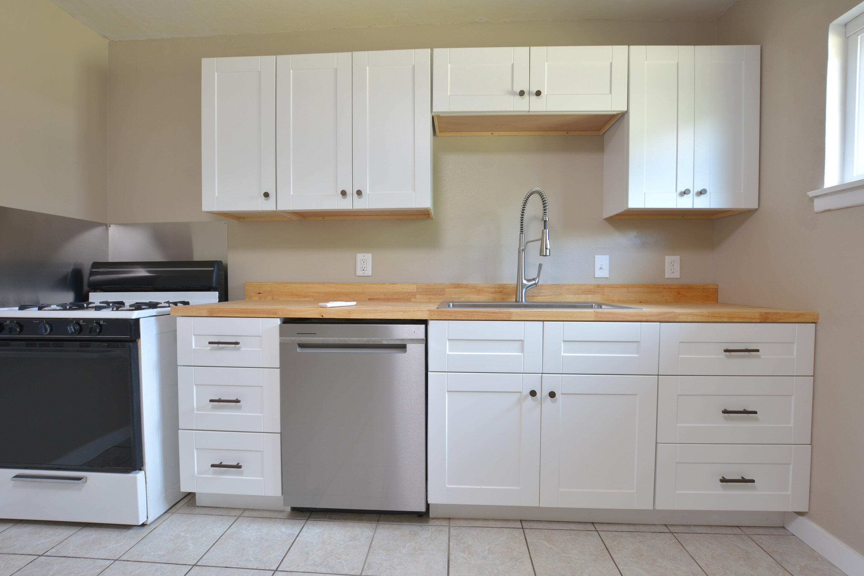 4608 Detroit Avenue Lubbock, TX 79413 - Photo 11 of 20 a kitchen with white cabinets and sink