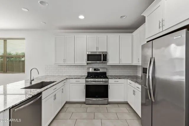 a kitchen with a sink stove and refrigerator