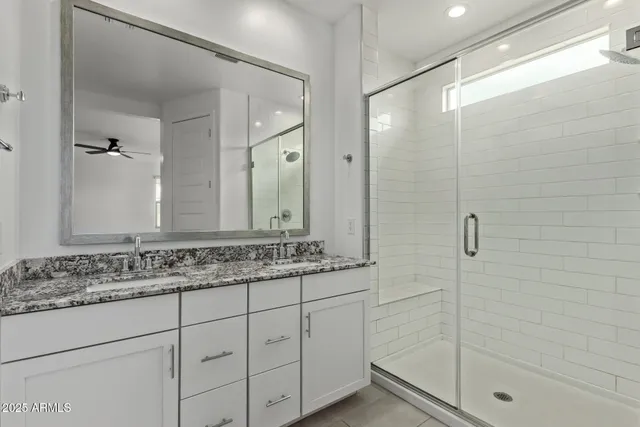 a bathroom with a shower sink and mirror