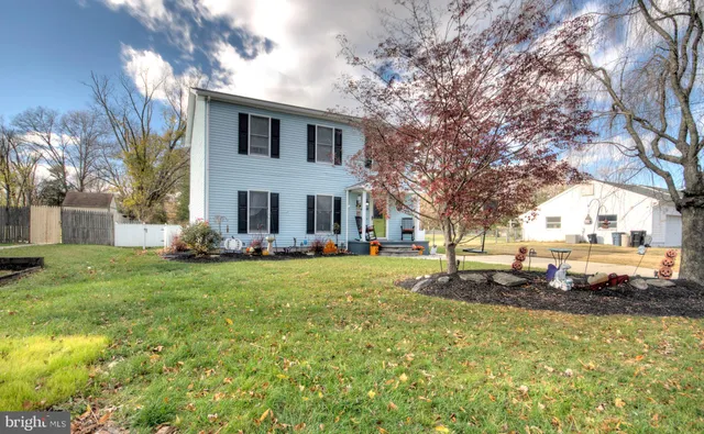 a view of a house with backyard sitting area and garden
