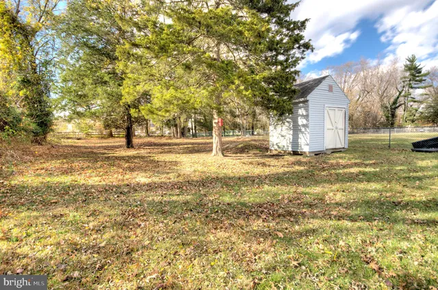 a swimming pool with yard and seating area
