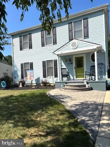 a view of a house with sitting area and garden
