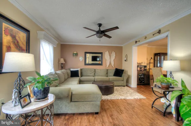 a kitchen with kitchen island granite countertop a sink cabinets and wooden floor