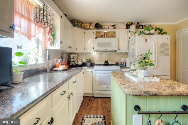 a living room with furniture a fireplace and a chandelier