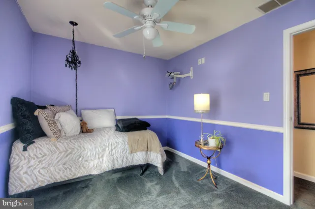 a kitchen with a refrigerator and a wooden floor