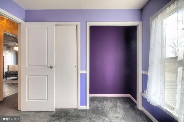 a en suite bathroom with a granite countertop sink and a mirror