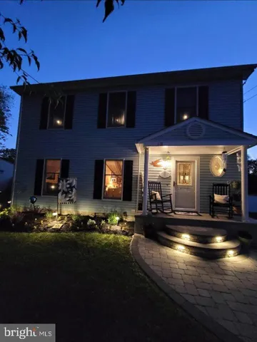 a kitchen with sink cabinets and flat screen tv