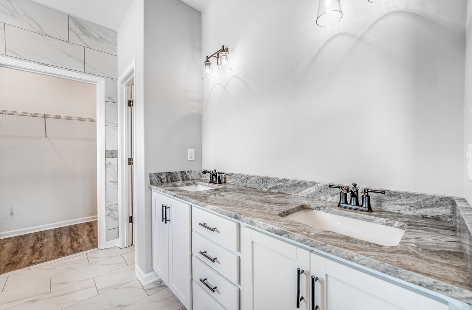 100 Blue Street Oakland, TN 38060 - Photo 23 of 40 a bathroom with a granite countertop sink and a mirror
