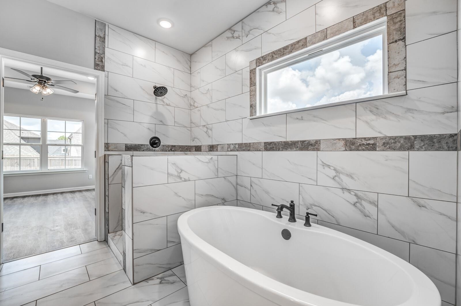 100 Blue Street Oakland, TN 38060 - Photo 25 of 40 a white bath tub sitting next to a shower