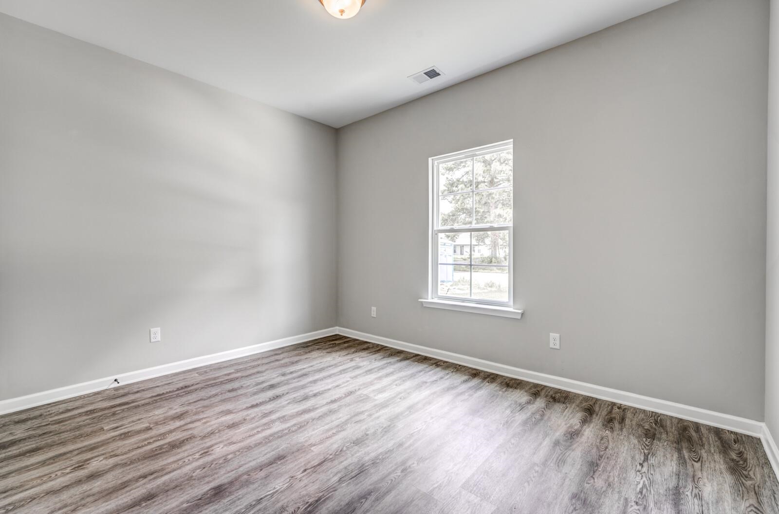 100 Blue Street Oakland, TN 38060 - Photo 26 of 40 a view of an empty room with wooden floor and a window
