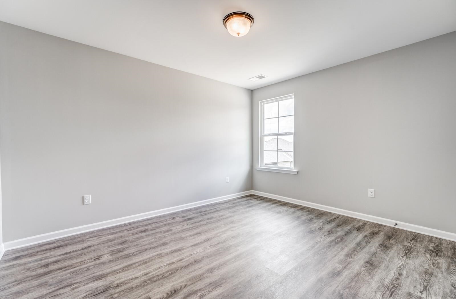100 Blue Street Oakland, TN 38060 - Photo 32 of 40 wooden floor in an empty room with a window